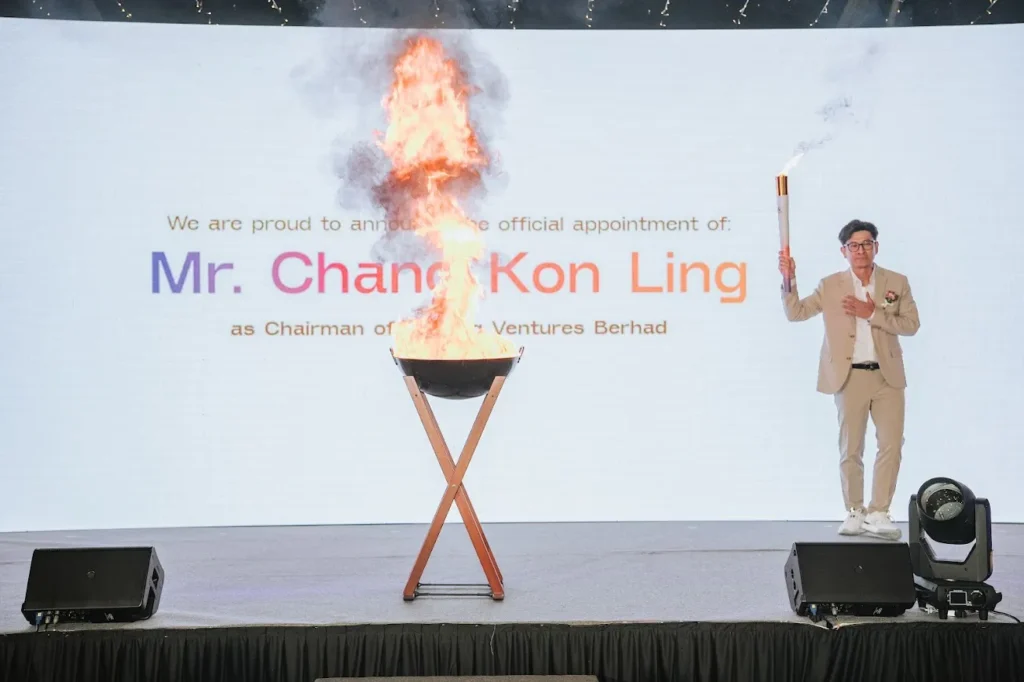 Mr. Chang Kon Ling as the new chairman of Nexting holding torch during leadership transition ceremony